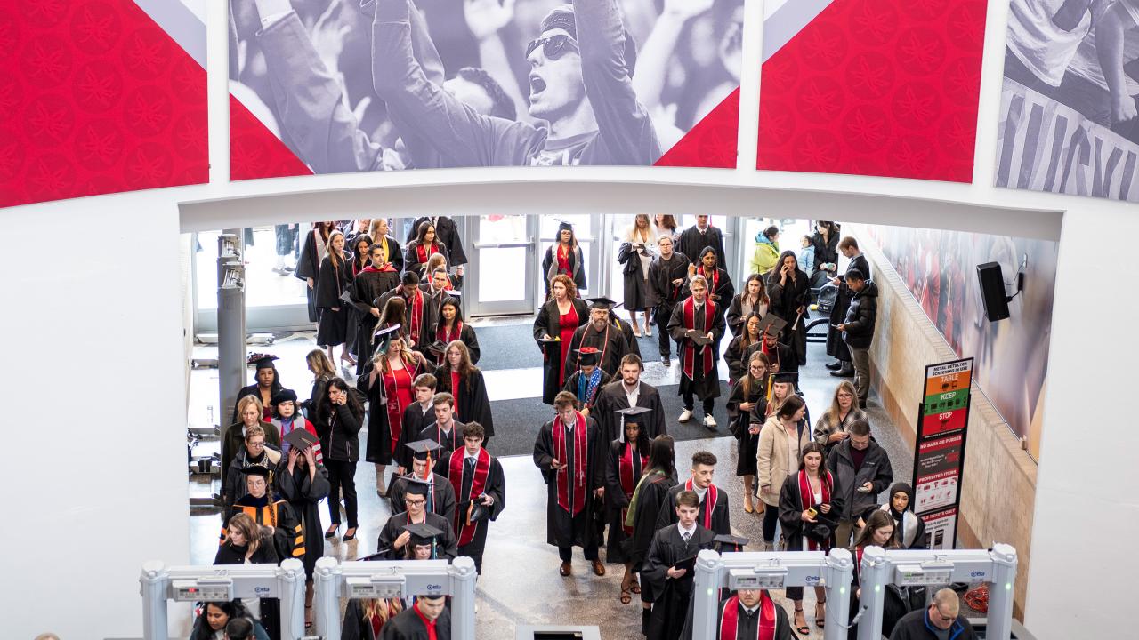Group of graduates filing into the Schottenstein center