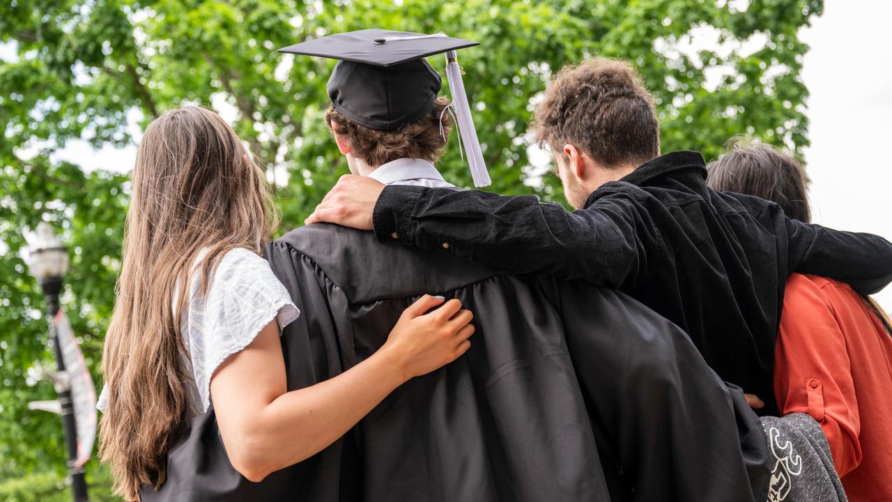 Graduate and family facing away from the camera