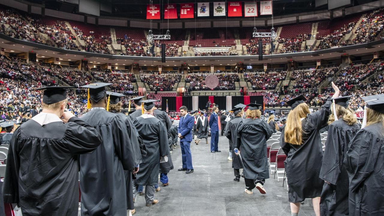 Graduates processing to seats
