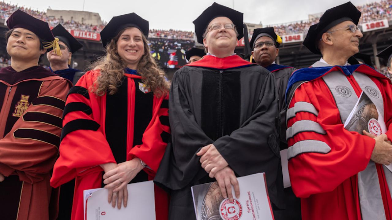 Faculty members watching spring commencement